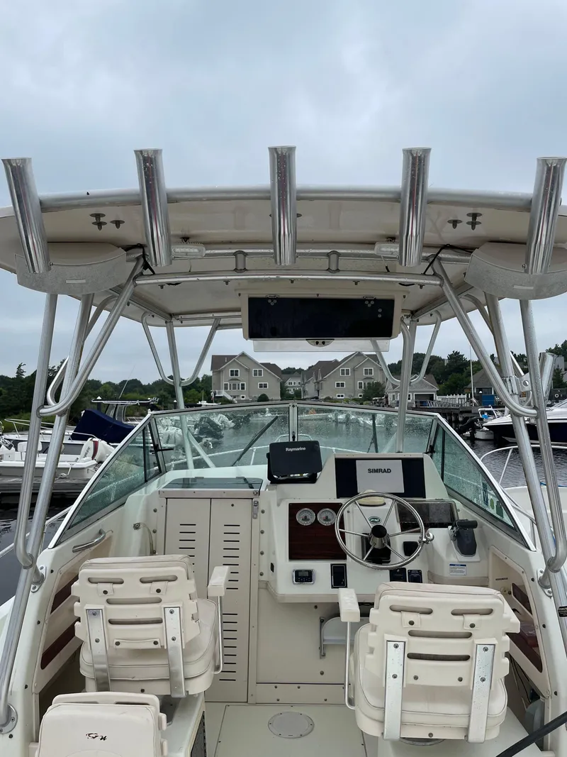 Slide: The Image of 2000 Grady-White 232 Gulfstream WA boat interior with dual seats and steering console. - 9