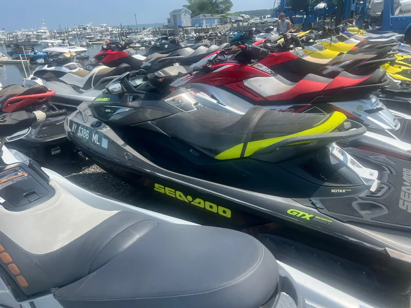 The Image of 2015 Sea-Doo GTX Limited iS 260 jet ski parked among others at a marina. - 1
