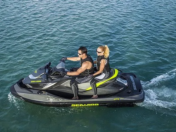 Slide: The Image of 2015 Sea-Doo GTX Limited iS 260 jet ski with two riders on open water. - 8