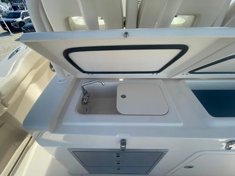 Slide: The Image of 2025 Grady-White Canyon 326 boat sink and storage area. - 11