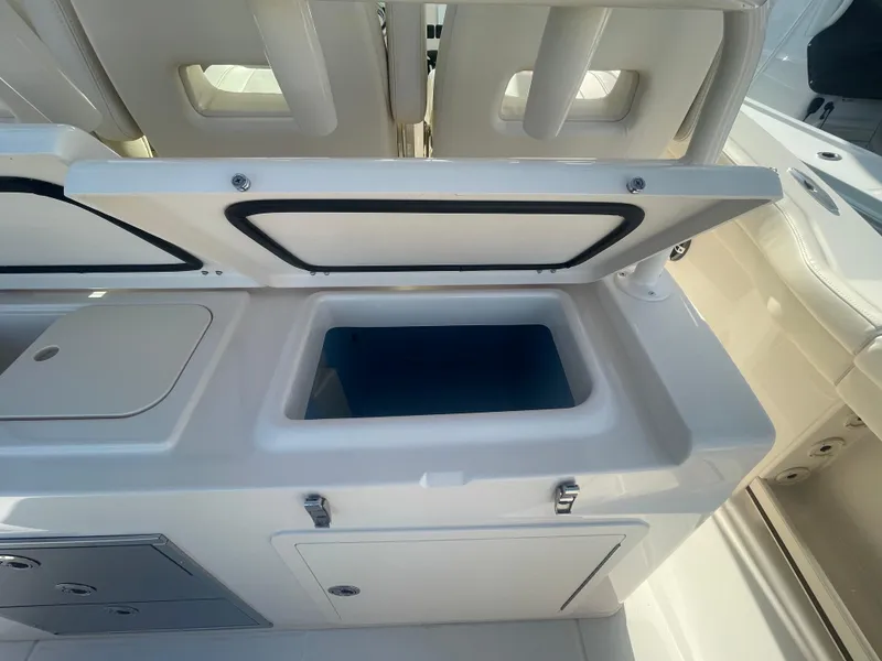 Slide: The Image of 2025 Grady-White Canyon 326 boat interior with open storage compartment. - 12