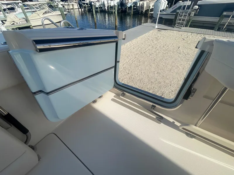 Slide: The Image of 2025 Grady-White Canyon 326 boat interior with open hatch, dockside view. - 13