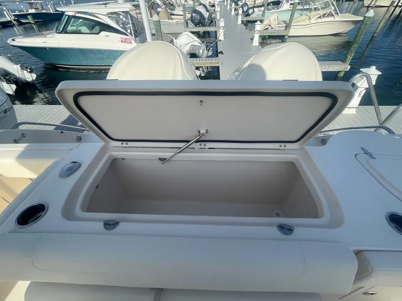 Slide: The Image of 2025 Grady-White Canyon 326 boat with open storage compartment at marina. - 15