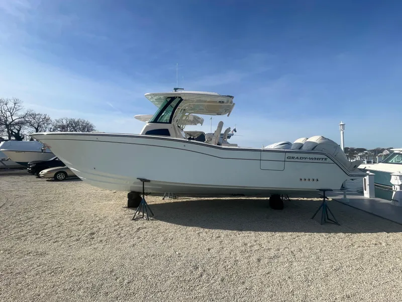 Slide: The Image of 2025 Grady-White Canyon 326 boat on display, side view, outdoors. - 2