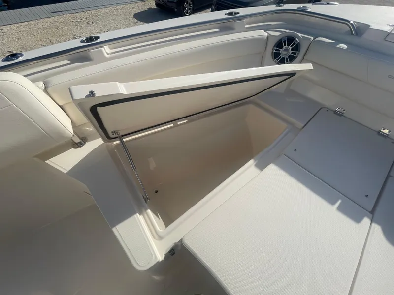 Slide: The Image of 2025 Grady-White Canyon 326 boat storage compartment, open lid, white interior. - 4