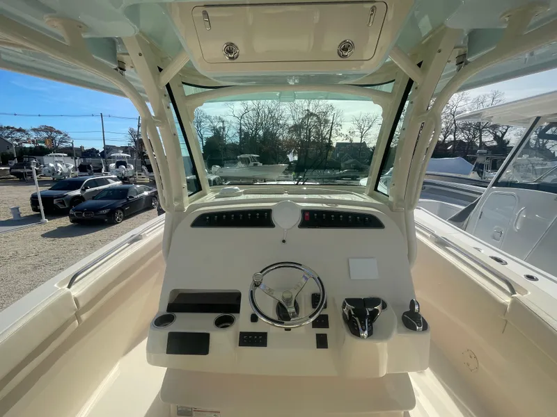 Slide: The Image of 2025 Grady-White Canyon 326 boat helm with steering wheel and controls. - 6