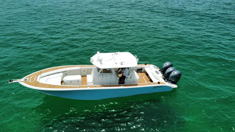 Slide: The Image of 2012 Yellowfin 39 Open boat on clear green water, aerial view. - 11