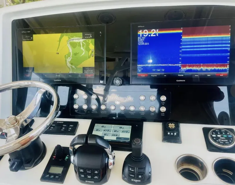 Slide: The Image of 2012 Yellowfin 39 Open boat dashboard with navigation and sonar displays. - 12