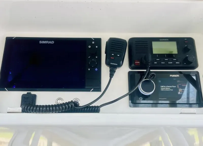 Slide: The Image of Simrad and Garmin marine electronics on 2012 Yellowfin 39 Open boat dashboard. - 13