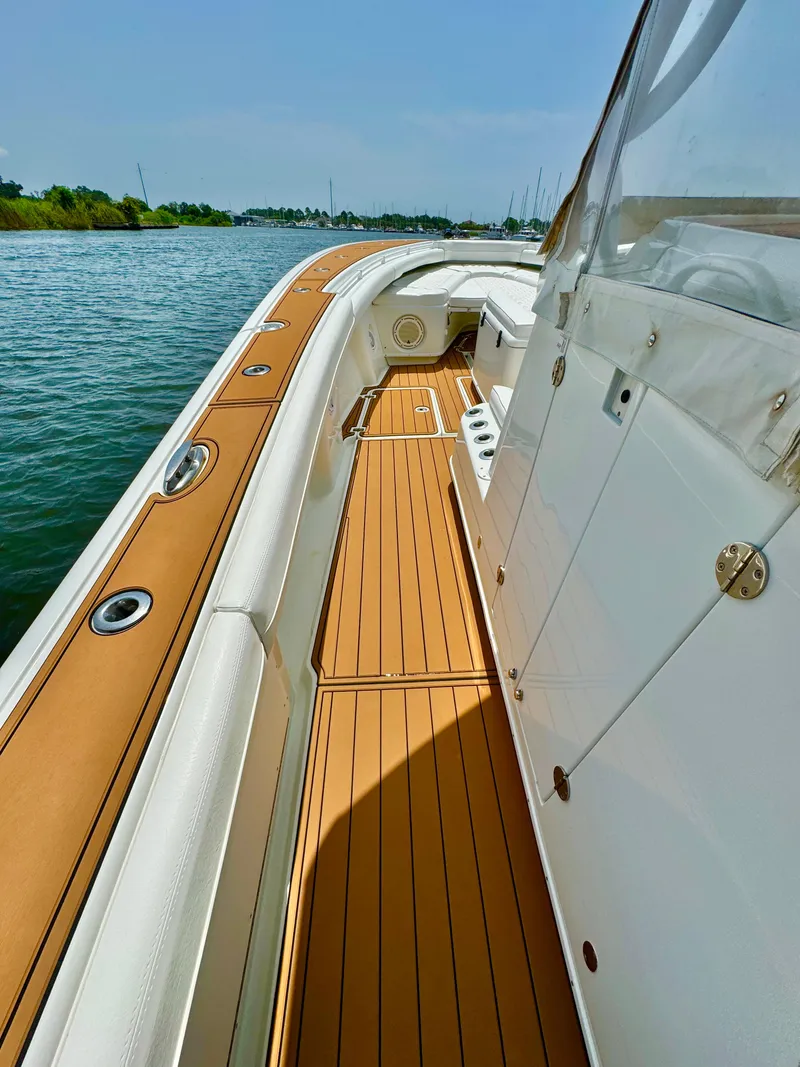 Slide: The Image of 2012 Yellowfin 39 Open boat with teak deck, cruising on calm waters. - 19