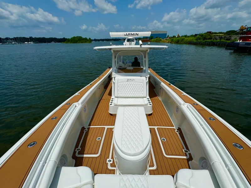 Slide: The Image of 2012 Yellowfin 39 Open boat on calm water, featuring spacious deck and modern design. - 21