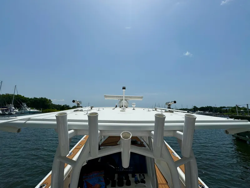 Slide: The Image of 2012 Yellowfin 39 Open boat on water, sunny day, marina in background. - 25