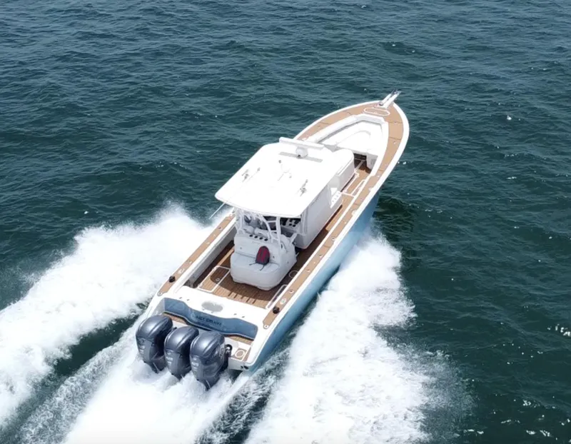 Slide: The Image of 2012 Yellowfin 39 Open boat cruising on the ocean with triple outboard engines. - 3