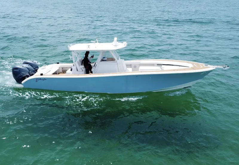 Slide: The Image of 2012 Yellowfin 39 Open boat cruising on clear blue water. - 6