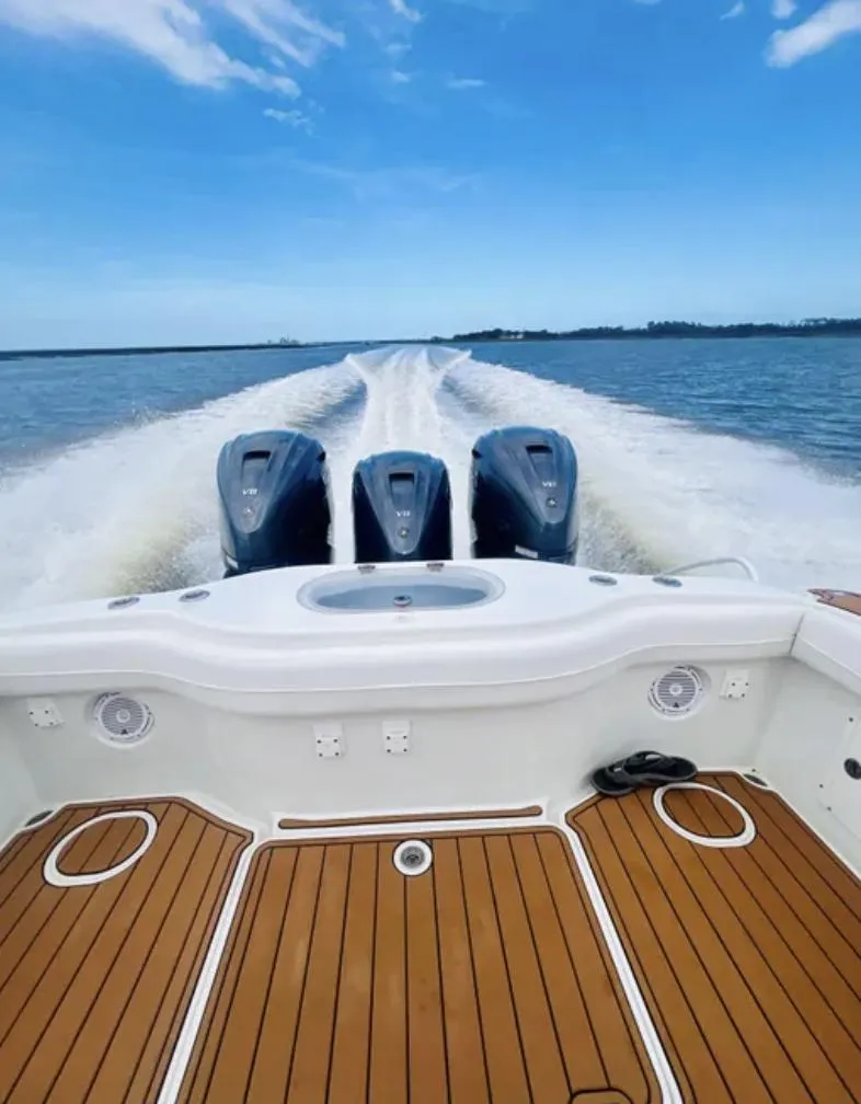 Slide: The Image of 2012 Yellowfin 39 Open boat with triple engines cruising on open water. - 7
