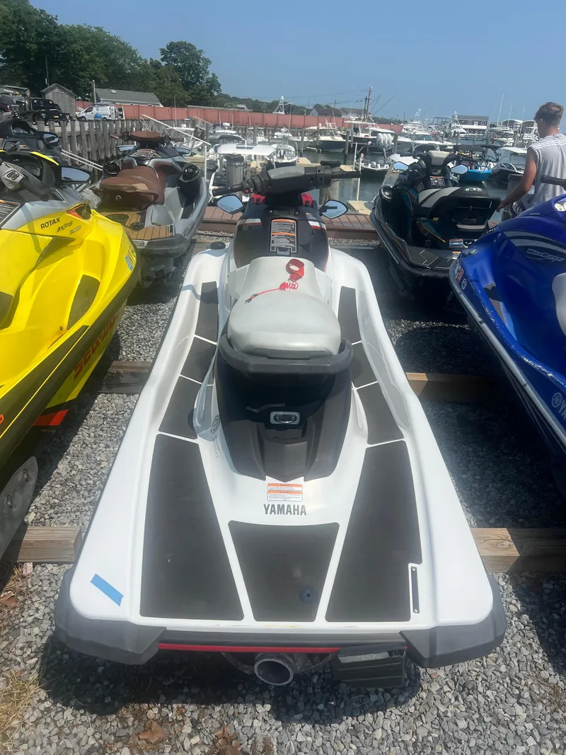 Slide: The Image of 2018 Yamaha WaveRunner EX Sport jet ski parked among others in a marina. - 4