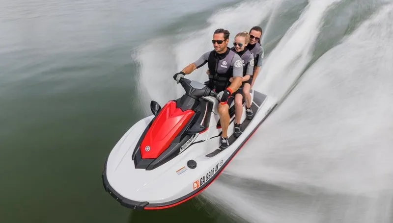 Slide: The Image of Three people riding a 2018 Yamaha WaveRunner EX Sport on water. - 8