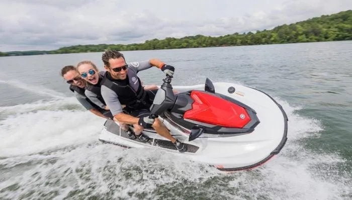 Slide: The Image of Three people riding a 2018 Yamaha WaveRunner EX Sport on a lake. - 9