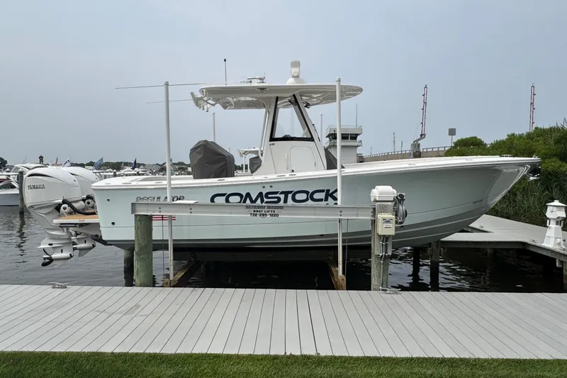The Image of 2025 Regulator 28 boat docked, featuring Yamaha engines and "Comstock" branding. - 0
