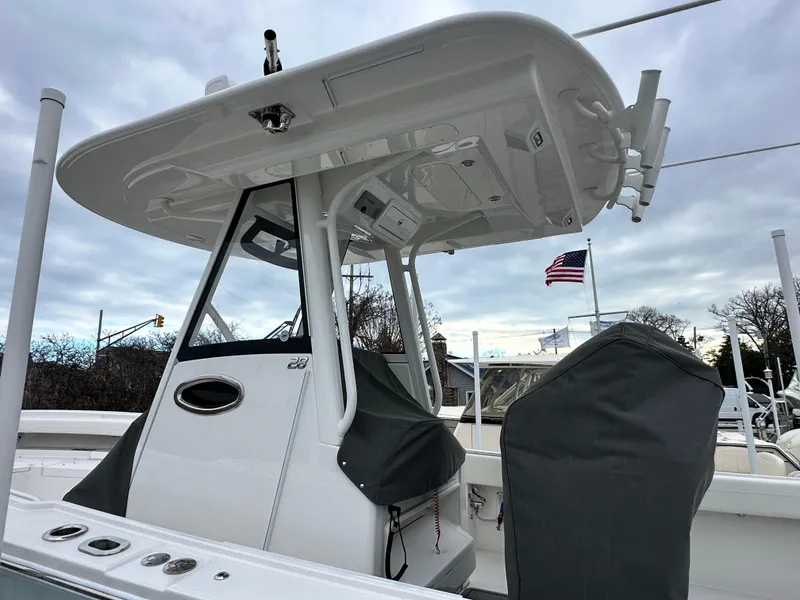 Slide: The Image of 2025 Regulator 28 boat with T-top and American flag in background. - 10