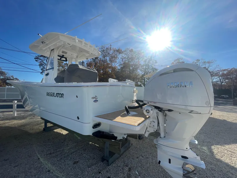 Slide: The Image of 2025 Regulator 28 boat with Yamaha outboard motor under bright sun. - 11