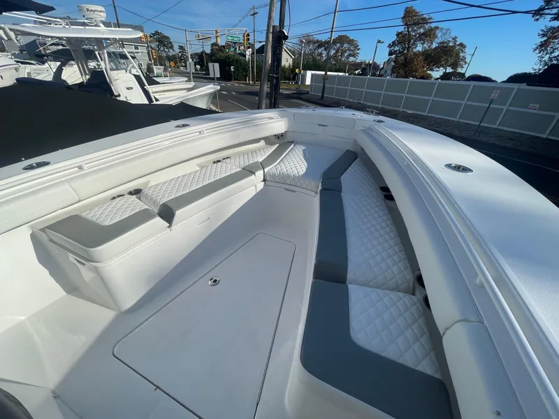 Slide: The Image of 2025 Regulator 28 boat interior with cushioned seating and storage compartments. - 16