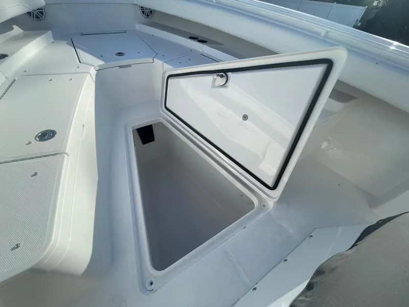 Slide: The Image of 2025 Regulator 28 boat storage compartment open, showcasing spacious interior. - 20