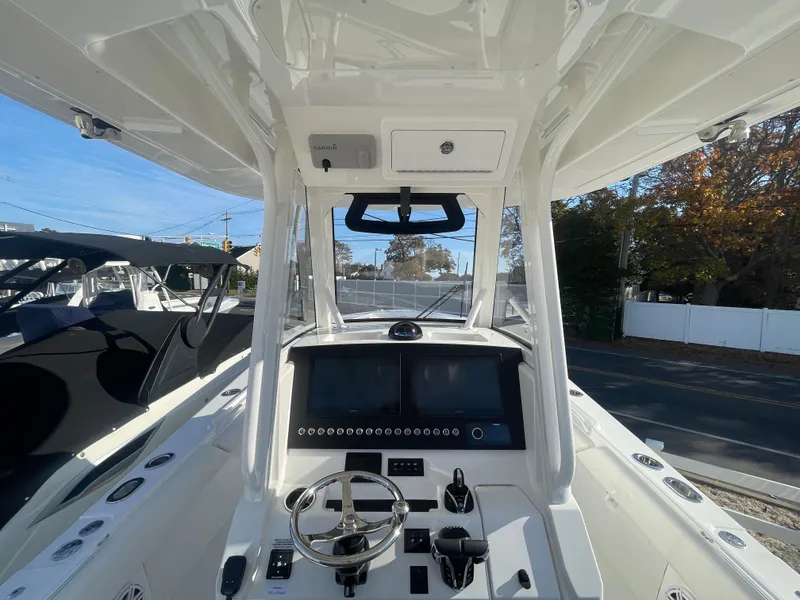 Slide: The Image of 2025 Regulator 28 boat cockpit with modern steering and navigation controls. - 25