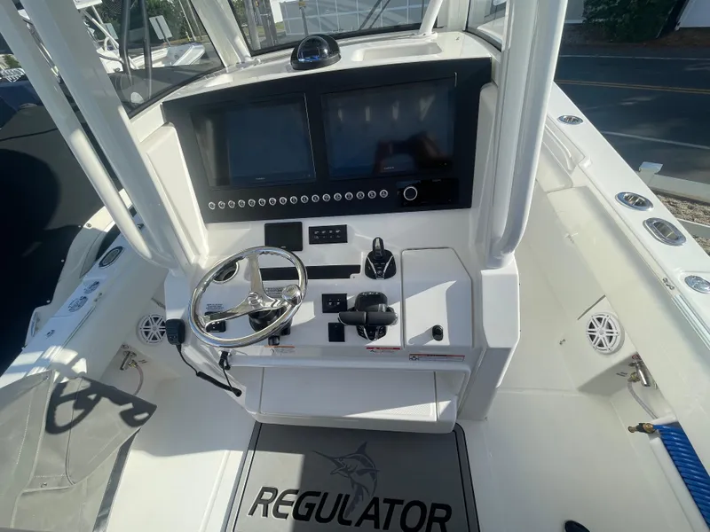 Slide: The Image of 2025 Regulator 28 boat cockpit with modern controls and dual screens. - 28