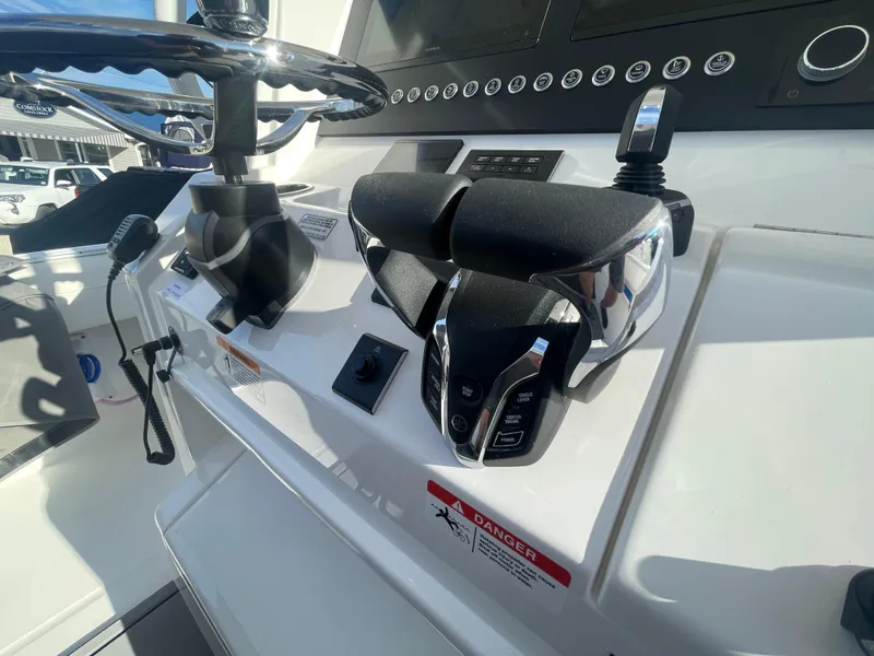 Slide: The Image of 2025 Regulator 28 boat helm with modern controls and steering wheel. - 29
