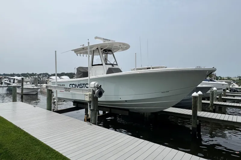 Slide: The Image of 2025 Regulator 28 boat docked at marina, side view. - 3