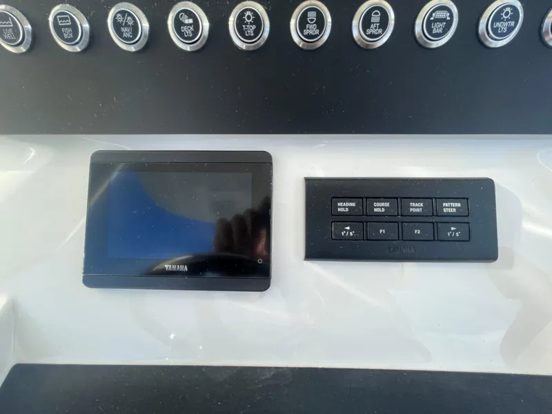 Slide: The Image of Control panel of 2025 Regulator 28 boat with Yamaha display and switches. - 31