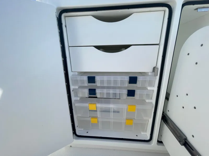 Slide: The Image of Storage compartment with drawers and tackle boxes on a 2025 Regulator 28 boat. - 37