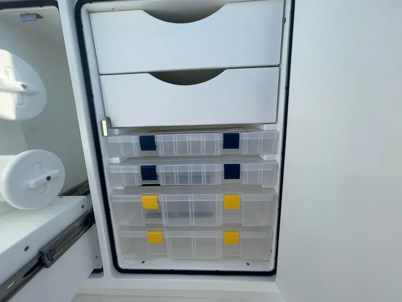 Slide: The Image of Regulator 28 boat storage compartments with organized tackle boxes, 2025 model. - 39