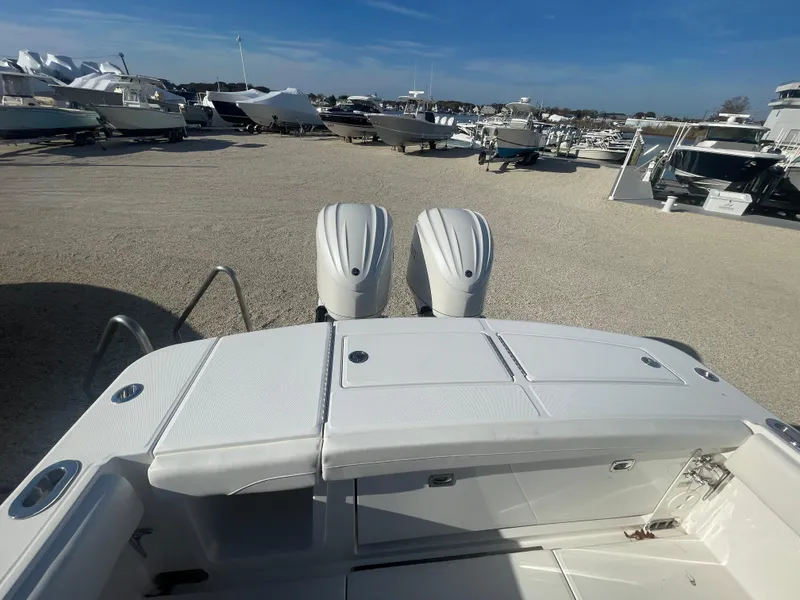 Slide: The Image of 2025 Regulator 28 boat with dual engines in a marina setting. - 44