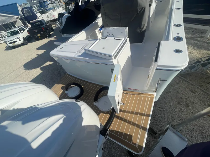 Slide: The Image of 2025 Regulator 28 boat with dual engines and spacious deck in a marina setting. - 45