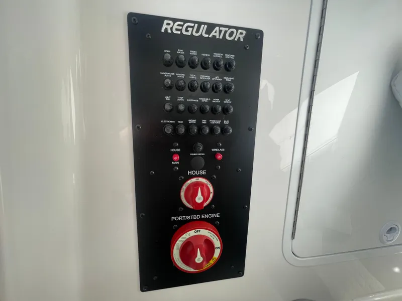 Slide: The Image of Control panel of 2025 Regulator 28 boat with switches and engine controls. - 48