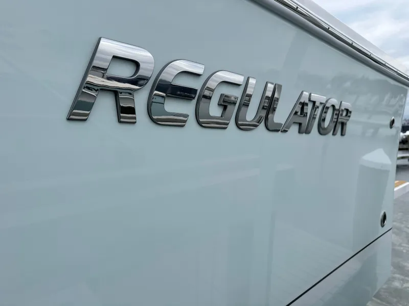 Slide: The Image of 2025 Regulator 28 boat logo on sleek white hull. - 49