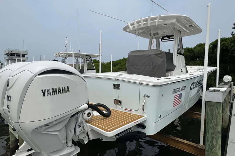 Slide: The Image of 2025 Regulator 28 boat with Yamaha engine, docked, featuring sleek design and modern amenities. - 5