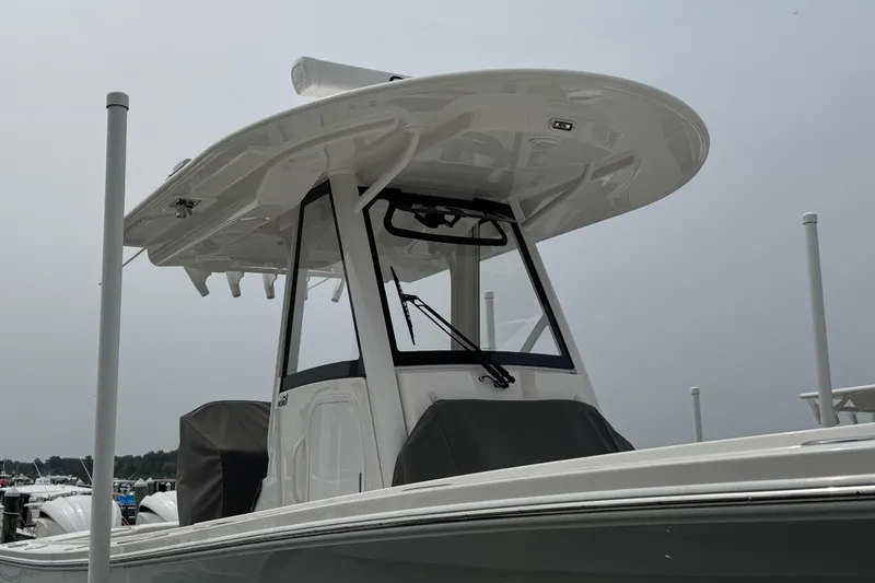 Slide: The Image of 2025 Regulator 28 boat with T-top and sleek design in marina setting. - 7