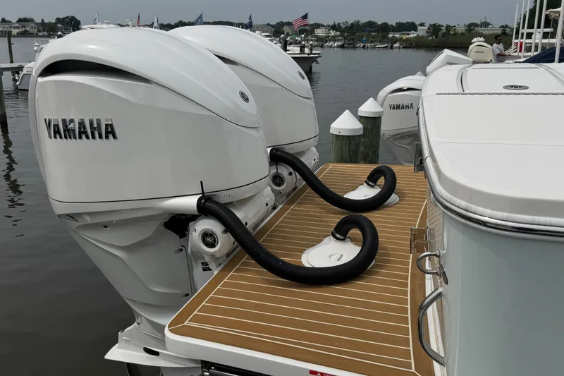 Slide: The Image of 2025 Regulator 28 boat with dual Yamaha outboard engines at a marina. - 8