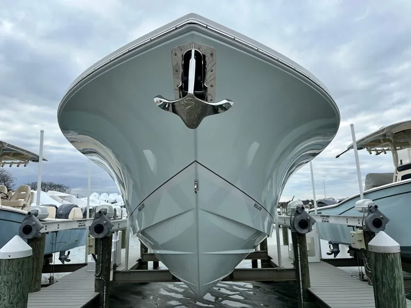 Slide: The Image of 2025 Regulator 28 boat docked, viewed from the front under a cloudy sky. - 9