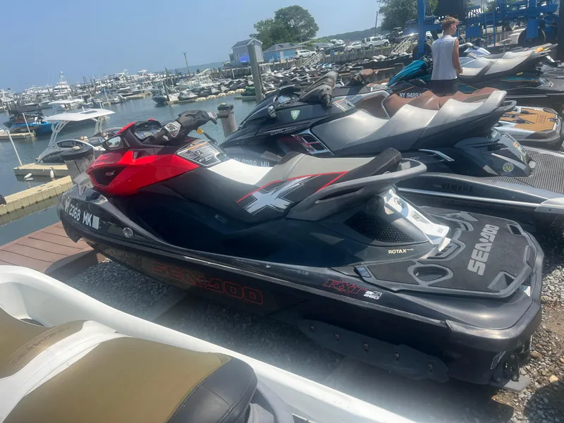 The Image of 2014 Sea-Doo RXT-X aS 260 jet ski docked at a marina. - 1