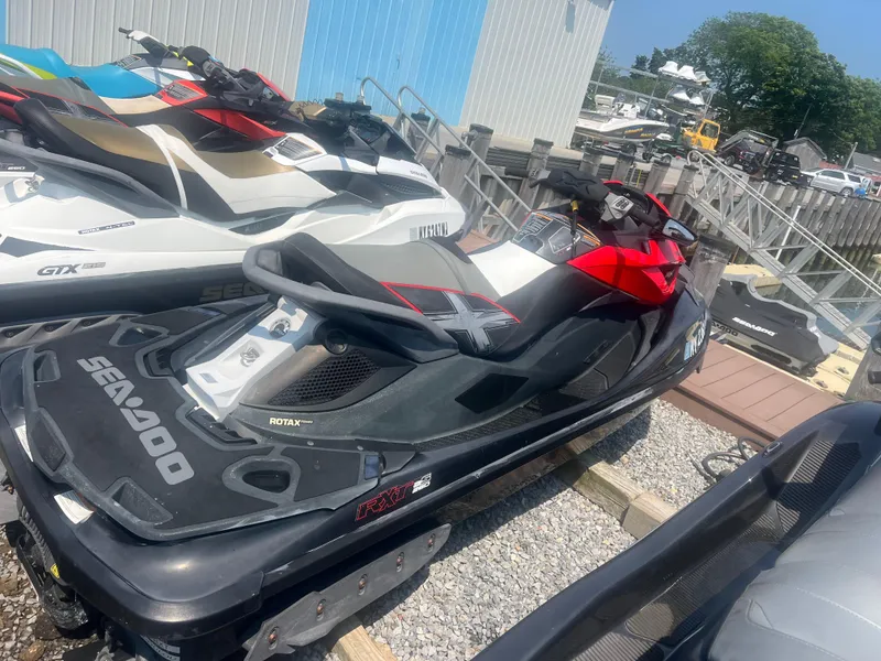 Slide: The Image of 2014 Sea-Doo RXT-X aS 260 jet ski parked on gravel near docks. - 8