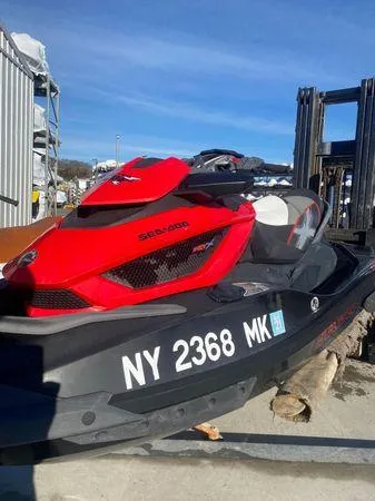 Slide: The Image of 2014 Sea-Doo RXT-X aS 260 jet ski, red and black, parked outdoors. - 9
