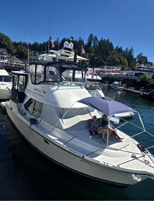 Slide: The Image of 2000 Bayliner 4087 Aft Cabin Motoryacht docked in scenic marina setting. - 1