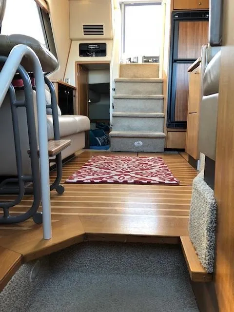 Slide: The Image of Interior of 2000 Bayliner 4087 Aft Cabin Motoryacht with stairs and seating area. - 10