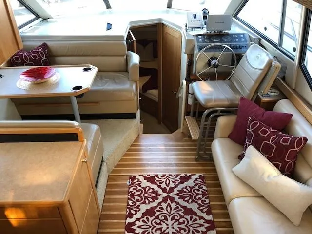 Slide: The Image of Interior of 2000 Bayliner 4087 Aft Cabin Motoryacht with seating, helm, and decorative pillows. - 11