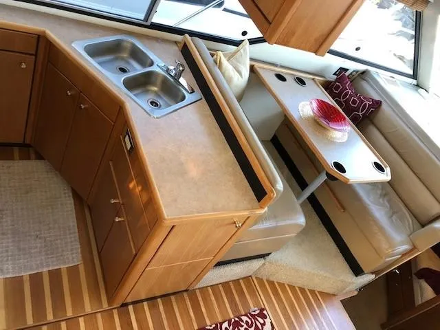 Slide: The Image of Interior of 2000 Bayliner 4087 Aft Cabin Motoryacht with kitchen and dining area. - 12
