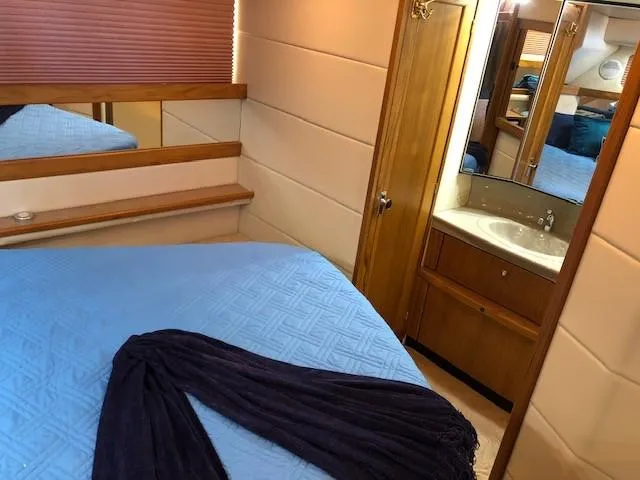 Slide: The Image of 2000 Bayliner 4087 Aft Cabin Motoryacht interior with bed, mirror, and sink. - 18